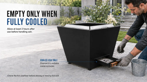 Gloved man removes the cooled ash pan from a black Legacy Heating 20 Inch Flat Smokeless Fire Pit beside a metal ash container after the unit has cooled for at least two hours.