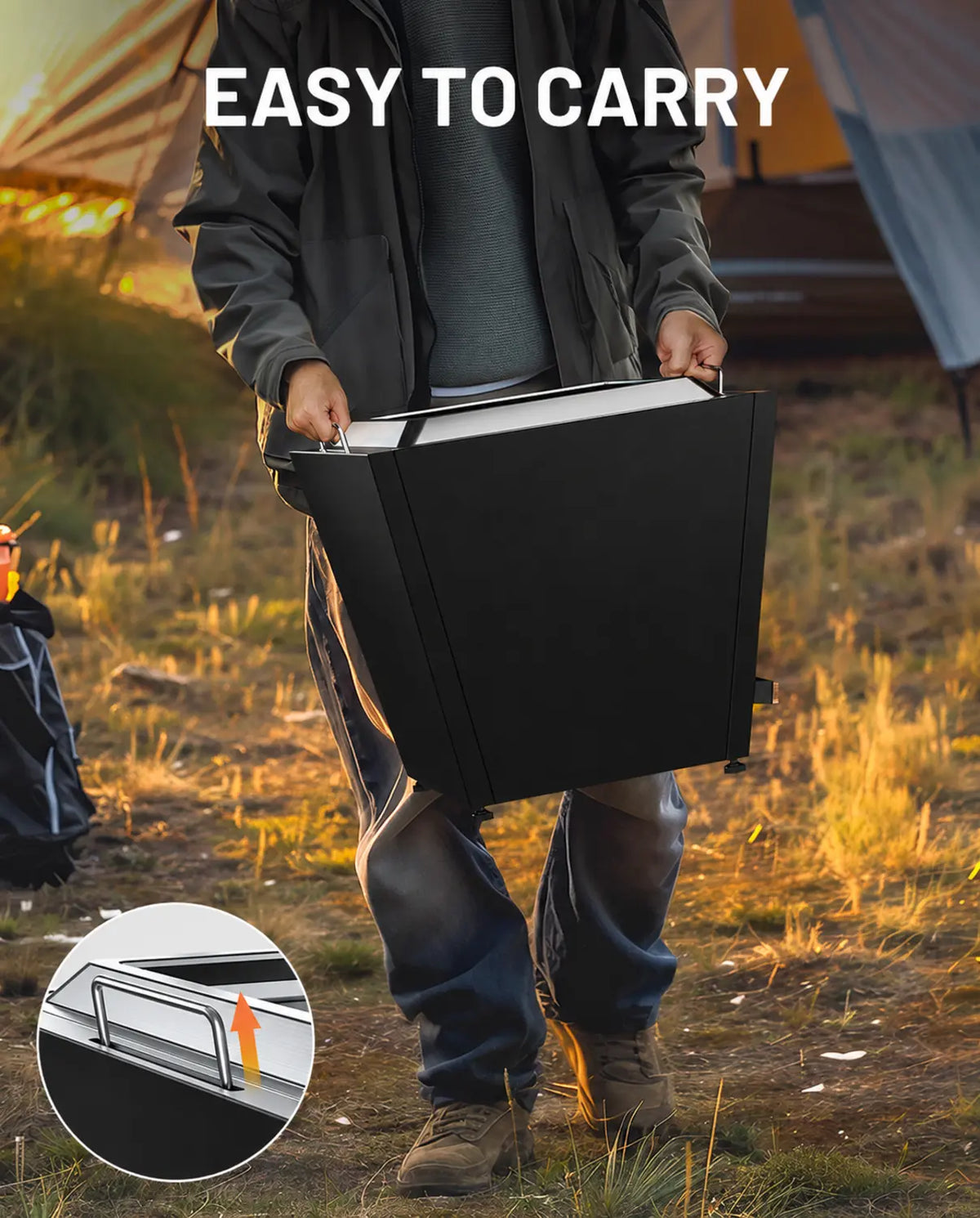 Person carrying a black LEGACY HEATING 20-inch Flat Smokeless Fire Pit by its two stainless steel folding handles at a campsite, with an inset close-up showing the raised handle.