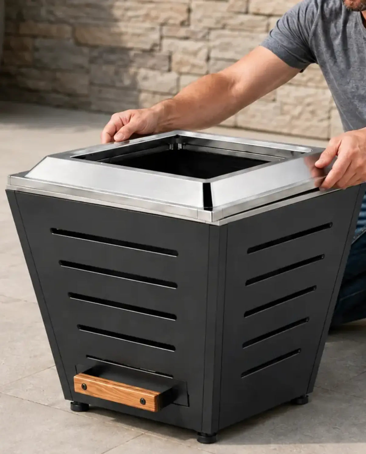 Adult assembling a LEGACY HEATING 20 Inch Slatted Smokeless Fire Pit by hand without screws, bolts, or installation tools.