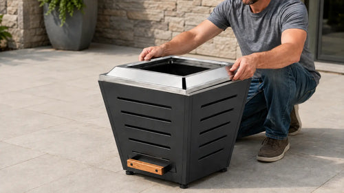 Adult assembling a Legacy Heating 20-inch black slatted smokeless fire pit by fitting the stainless steel fire ring without screws or tools.