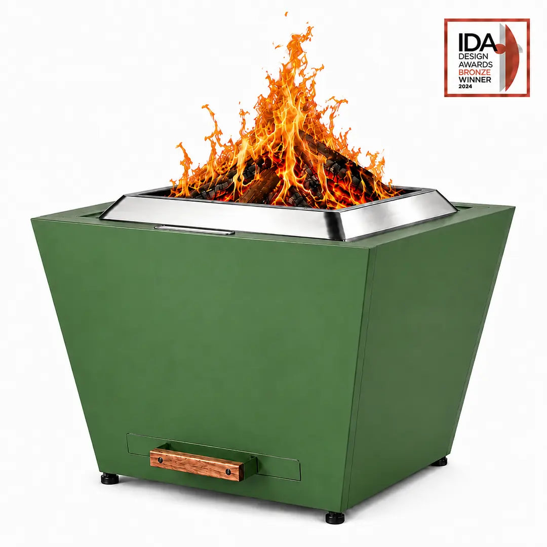 LEGACY HEATING 25 Inch Jewel Green Flat Smokeless Fire Pit with burning firewood, solid inverted-pyramid steel panels, a raised stainless steel fire ring, and a pull-out ash pan with a wooden handle.