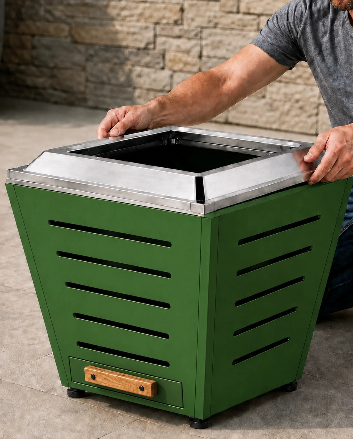 Adult easily placing the stainless steel fire ring onto a LEGACY HEATING 25 inch Jewel Green slatted smokeless fire pit, highlighting its quick screw-free assembly design.